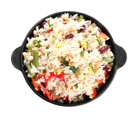 Boiled rice with vegetables in frying pan on white background