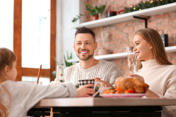 Happy family having Christmas dinner at home