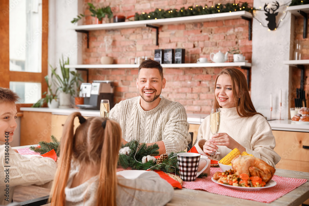 Wall mural happy family having christmas dinner at home