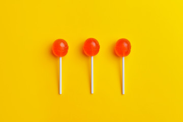 Tasty lollipops on color background