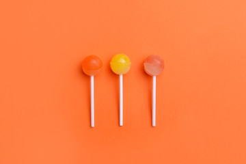 Tasty lollipops on color background