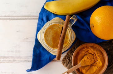 Healthy smoothie with turmeric and orangeg banana and cinnamon