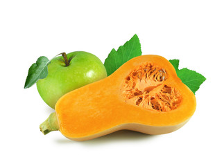 Half of orange pumpkin with seeds and green apple with leaf isolated on white background   
