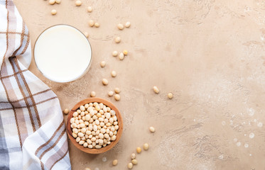 Soy milk and soy bean on beige background. Alternative Non-dairy milk concept. Vegan Beverage. Copy...