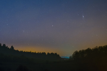 Naklejka na ściany i meble Night sky including the Triangulum and Andromeda Galaxy photographed from Lampenhain in the Odenwald in Germany.