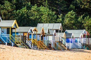 Fototapeta na wymiar Colourful beach huts on Wells beach at Wells