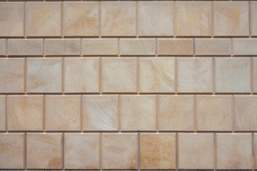 Background image - the wall of the building, lined with stone tiles of different sizes
