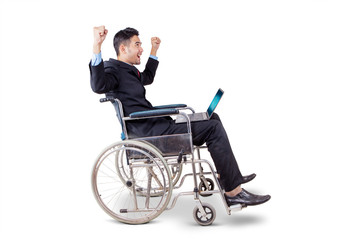 Businessman on wheelchair celebrating his success