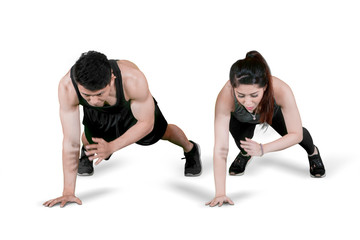 Obraz premium Young couple doing exercise by push up