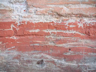 Background of a concrete wall with old traces of a red paint