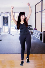 Fototapeta premium Caucasian woman cheering and raising her arms