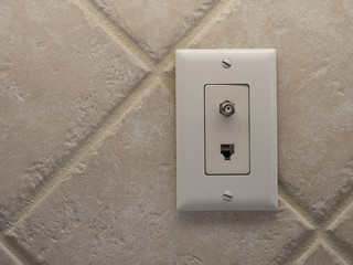 Coax cable outlet and land line phone wall outlet. Coaxial connection for TV and high speed...