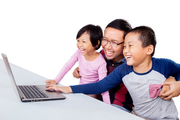 Children laughing while their father teaching them