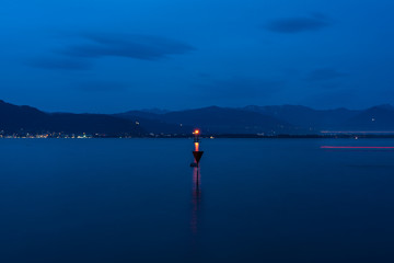 Fototapeta na wymiar dark sea lake constanz germany bodensee lighthouse