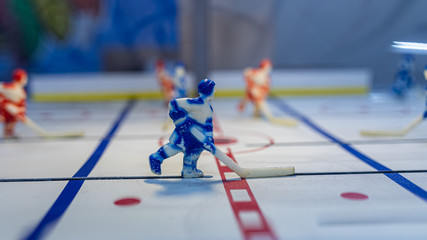 Up close shot of a worn figure of a hockey player in a blue uniform