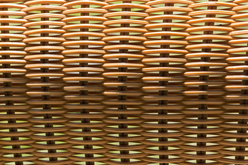 Horizontal rattan weave with vertical bases illuminated by the bright sun from above