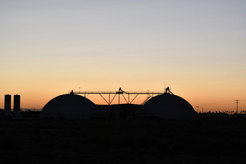 Fototapeta na wymiar Two silos in a sunset