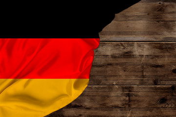 color national flag of modern state of Germany, beautiful silk, background old wood, concept of tourism, economy, politics, emigration, independence day, copy space, template, horizontal
