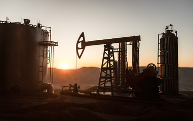 Creative artwork decoration. Oil pump and oil refining factory at sunset. Energy industrial...