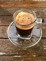 Close up coffee cup on wood table. Vertical photo.