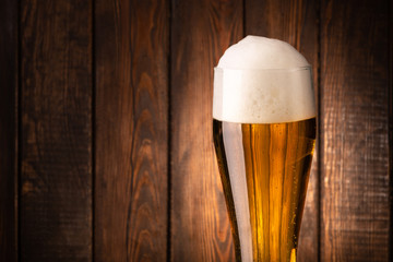 Glass beer on wood background.
