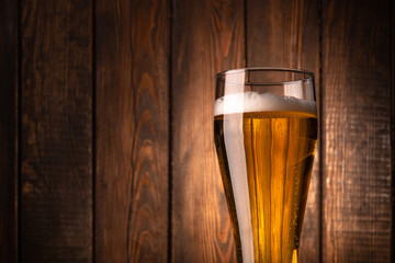 Glass beer on wood background.