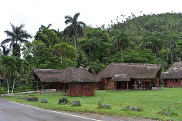 Fototapeta na wymiar Red buildings with straw roof in rural Vinales