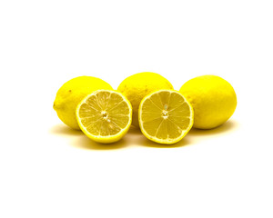 Studio shot pile of organic raw lemons with slice cuts isolated on white