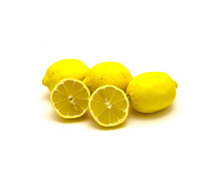 Studio shot pile of organic raw lemons with slice cuts isolated on white