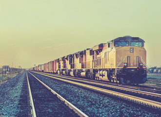 Freight Rail cargo train carrying heavy goods on long haul trip in the desert of Arizona,USA.