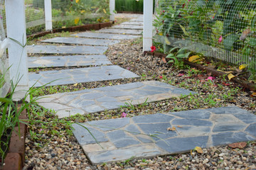 stone block pathway in flower garden