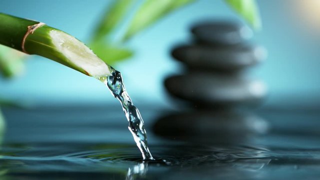 Super slow motion of leaking water stream from bamboo, spa and wellness concept. Filmed on very high speed cinema camera, 1000 fps.