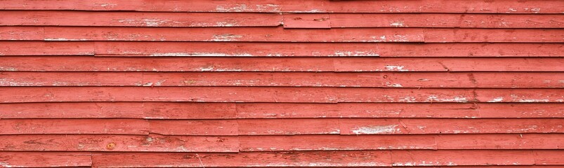 red peeling paint on weather worn red barn © JMP Traveler