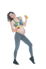 Fototapeta na wymiar Pregnant woman training with dumbbells to stay active. Pregnant woman practicing fitness and working out during pregnancy Slim pregnant woman is engaged in fitness. Isolated white background.