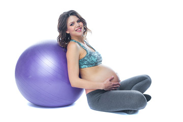 Portrait of a beautiful young pregnant woman exercises with fitball. Working out and fitness, pregnancy concept. Isolated white background.