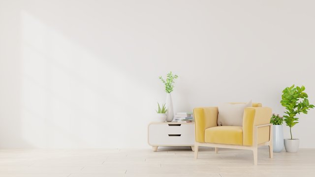 Living room with yellow fabric armchair, book and plants on empty white wall background.
