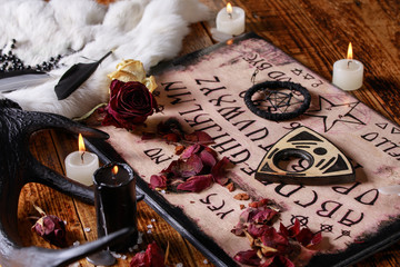 Talking board and planchette, also known as Ouija board, used for communicating with the dead and...