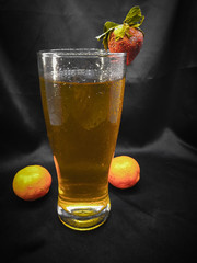 Fresh and cold fruit tea isolated on black background