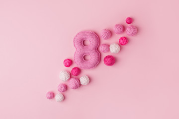Happy International Women’s Day celebrate on March 8, congratulatory CARD. Handmade crocheting pink Number eight and yarn ball, minimal concept for seasonal holiday or girl birthday party, copy space