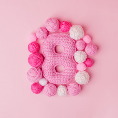 March 8 Women's Day card with number eight from crocheting knit, hobby handcraft handmade concept of congratulation, pink idea for happy birthday girl party 8-years, copy space