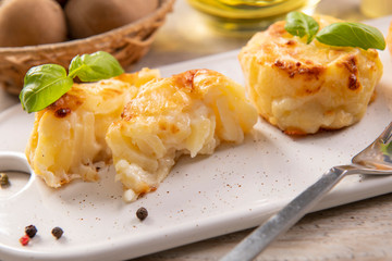Small casseroles made from potatoes and cheese