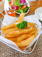 Delicious hot french fries served on table