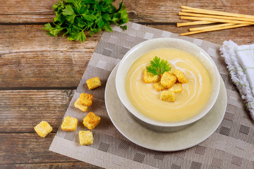 Delicious chicken creamy soup with croutons and italian bread sticks.