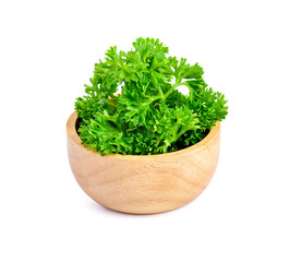 parsley in wooden bowl isolated on white background.