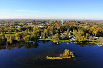 The aerial view of the waterfront residential area by Oneida Lake with stunning fall foliage near...