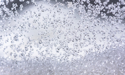 Naklejka na ściany i meble Close up of crystal sugar in Glass bottles on white background.