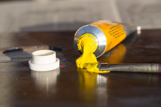 Close-Up Of Yellow Paint Tube On Table