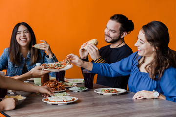 Mexican people eating Tacos al Pastor in a Taqueria in Mexico