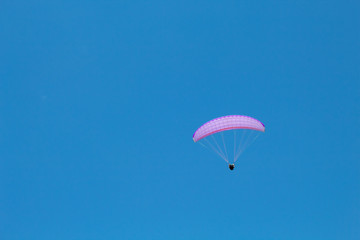 paraglider in flight in the blue sky