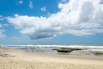 rocks, sand and sea of the city of Torres beach on a blue sky day